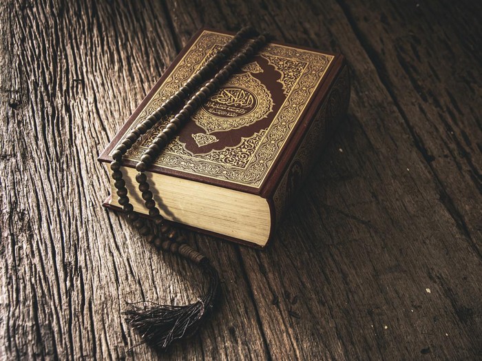 Koran - holy book of Muslims ( public item of all muslims ) on the table , still life .
