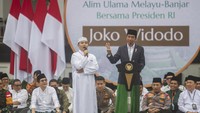 Presiden Joko Widodo memberikan pertanyaan kepada peserta saat hadir pada Muktamar Rabithah Melayu-Banjar.
