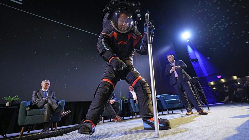 Axiom Space chief engineer Jim Stein demonstrates a prototype spacesuit, Wednesday, March 15, 2023, in Houston. NASA selected Axiom Space to design the spacesuits that its moonwalking astronauts will wear when they step onto the lunar surface later this decade. (AP Photo/David J. Phillip)