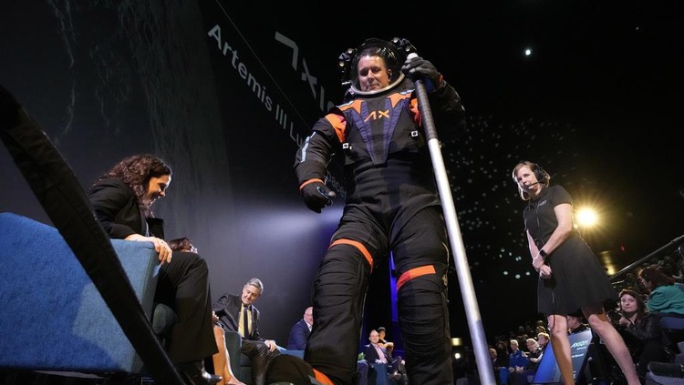 Axiom Space chief engineer Jim Stein demonstrates a prototype spacesuit, Wednesday, March 15, 2023, in Houston. NASA selected Axiom Space to design the spacesuits that its moonwalking astronauts will wear when they step onto the lunar surface later this decade. (AP Photo/David J. Phillip)
