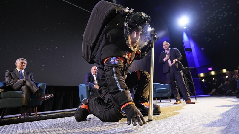 Axiom Space chief engineer Jim Stein demonstrates a prototype spacesuit, Wednesday, March 15, 2023, in Houston. NASA selected Axiom Space to design the spacesuits that its moonwalking astronauts will wear when they step onto the lunar surface later this decade. (AP Photo/David J. Phillip)