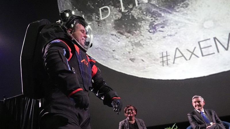 Axiom Space chief engineer Jim Stein demonstrates a prototype spacesuit, Wednesday, March 15, 2023, in Houston. NASA selected Axiom Space to design the spacesuits that its moonwalking astronauts will wear when they step onto the lunar surface later this decade. (AP Photo/David J. Phillip)