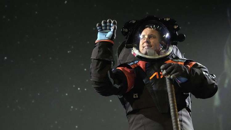 Axiom Space chief engineer Jim Stein demonstrates a prototype spacesuit, Wednesday, March 15, 2023, in Houston. NASA selected Axiom Space to design the spacesuits that its moonwalking astronauts will wear when they step onto the lunar surface later this decade. (AP Photo/David J. Phillip)