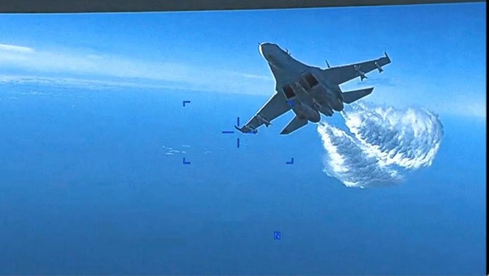 A Russian Su-27 military aircraft dumps fuel while flying towards a U.S. Air Force intelligence, surveillance, and reconnaissance unmanned MQ-9 aircraft, also known as the 