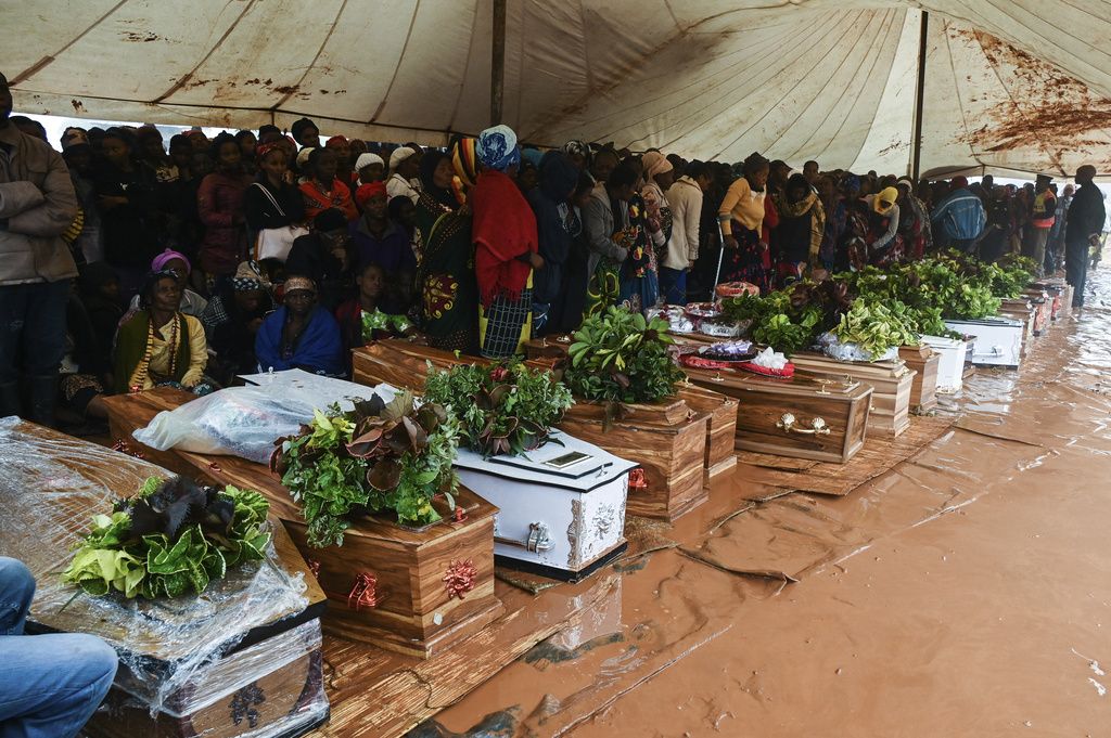 People attend the burial ceremony of some of the people who lost their lives following heavy rains caused by Cyclone Freddy in Blantyre, southern Malawi, Wednesday, March 15, 2023. After barreling through Mozambique and Malawi since late last week and killing hundreds and displacing thousands more, the cyclone is set to move away from land bringing some relief to regions who have been ravaged by torrential rain and powerful winds. AP Photo/Thoko Chikondi)