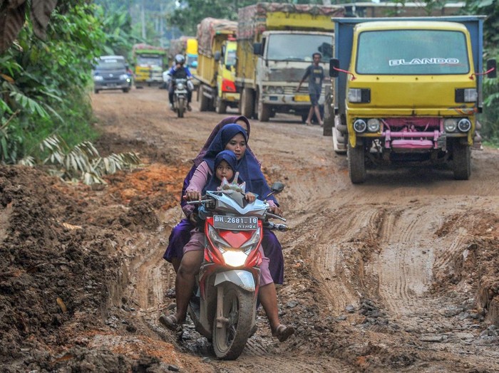 Pengendara melaju pelan saat melintasi Jalan Lintas Suak Kandis-Jambi yang rusak di Desa Pulau Mentaro, Muarojambi, Jambi, Kamis (16/3/2023). Jalan penghubung Kabupaten Tanjungjabung Timur dengan Kota Jambi itu bergelombang dan berlubang hingga kedalaman 60 cm di sejumlah titik. ANTARA FOTO/Wahdi Septiawan/aww.