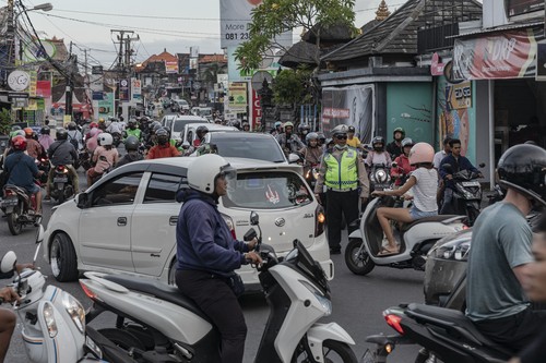 Motorcyclists travel on a street in Canggu, Bali, Indonesia, on Thursday, March 16, 2023. Foreign tourists in Bali wont be allowed to use motorcycles to get around the island after a string of accidents led to injuries and even deaths. Photographer: Nyimas Laula/Bloomberg via Getty Images