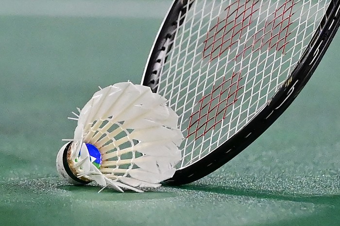 Chinas He Bingjiao picks up the shuttlecock with her racket between points with Japans Nozomi Okuhara in their womens singles badminton quarter final match during the Tokyo 2020 Olympic Games at the Musashino Forest Sports Plaza in Tokyo on July 30, 2021. (Photo by Pedro PARDO / AFP) (Photo by PEDRO PARDO/AFP via Getty Images)