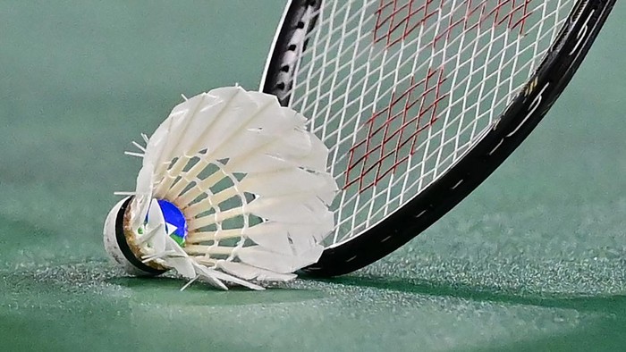 Chinas He Bingjiao picks up the shuttlecock with her racket between points with Japans Nozomi Okuhara in their womens singles badminton quarter final match during the Tokyo 2020 Olympic Games at the Musashino Forest Sports Plaza in Tokyo on July 30, 2021. (Photo by Pedro PARDO / AFP) (Photo by PEDRO PARDO/AFP via Getty Images)