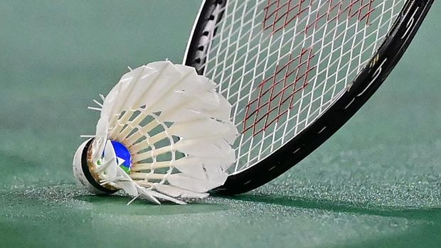 China's He Bingjiao picks up the shuttlecock with her racket between points with Japan's Nozomi Okuhara in their women's singles badminton quarter final match during the Tokyo 2020 Olympic Games at the Musashino Forest Sports Plaza in Tokyo on July 30, 2021. (Photo by Pedro PARDO / AFP) (Photo by PEDRO PARDO/AFP via Getty Images)