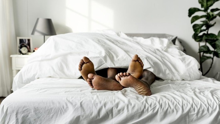 Black couple lying on bed together sex concept
