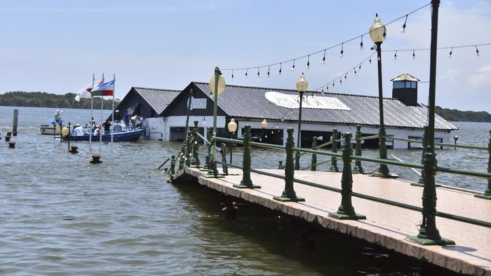 The Marine Museum of Puerto Bolivar, detached from the dock, is partially inundated in water after an earthquake that shook Machala, Ecuador, Saturday, March 18, 2023. The U.S. Geological Survey reported an earthquake with a magnitude of about 6.8 that was centered just off the Pacific Coast, about 50 miles (80 kilometers) south of Guayaquil. (AP Photo/Jorge Sanchez)