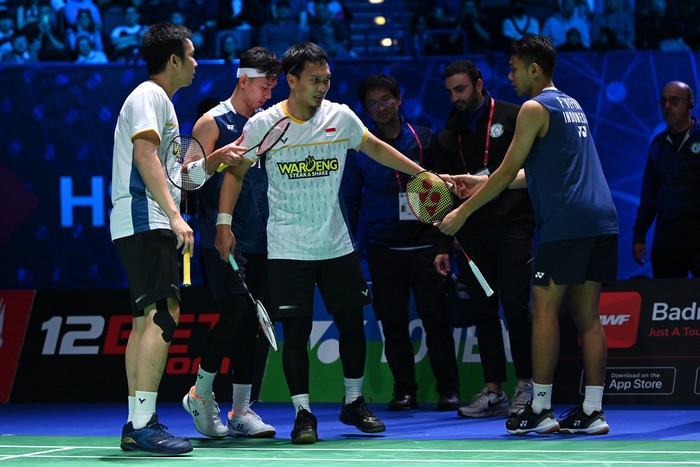 Indonesias Mohammad Ahsan (C) is helped up after falling during the mens doubles final with Indonesias Hendra Setiawan against Indonesias Fajar Alfian and Indonesias Muhammad Rian Ardianto at the All England Open Badminton Championships at the Utilita Arena in Birmingham, central England, on March 19, 2023. (Photo by Oli SCARFF / AFP) (Photo by OLI SCARFF/AFP via Getty Images)