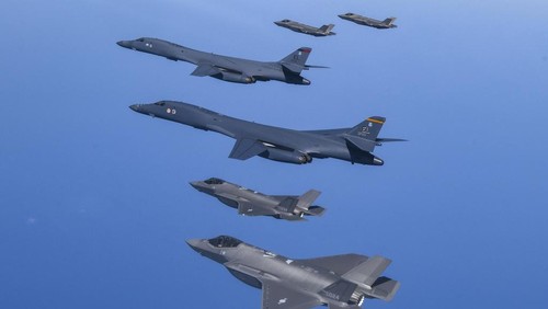 In this photo provided by South Korea Defense Ministry, U.S. Air Force B-1B bombers, center, fly in formation with South Koreas Air Force F-35A fighter jets and U.S. Air Force F-16 fighter jets, bottom left, over the South Korea Peninsula during a joint air drill in South Korea, Sunday, March 19, 2023. North Korea launched a short-range ballistic missile toward the sea on Sunday, its neighbors said, ramping up testing activities in response to U.S.-South Korean military drills that it views as an invasion rehearsal. (South Korea Defense Ministry via AP)