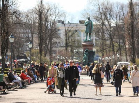 HELSINKI, UUSIMAA, FINLAND - 2022/05/15: People have a picnic in front of cherry blossoms during the Sakura festival. Every year in May, Sakura festival of Japanese culture takes place in Helsinki in Roihuvuori Cherry Park. (Photo by Takimoto Marina/SOPA Images/LightRocket via Getty Images)