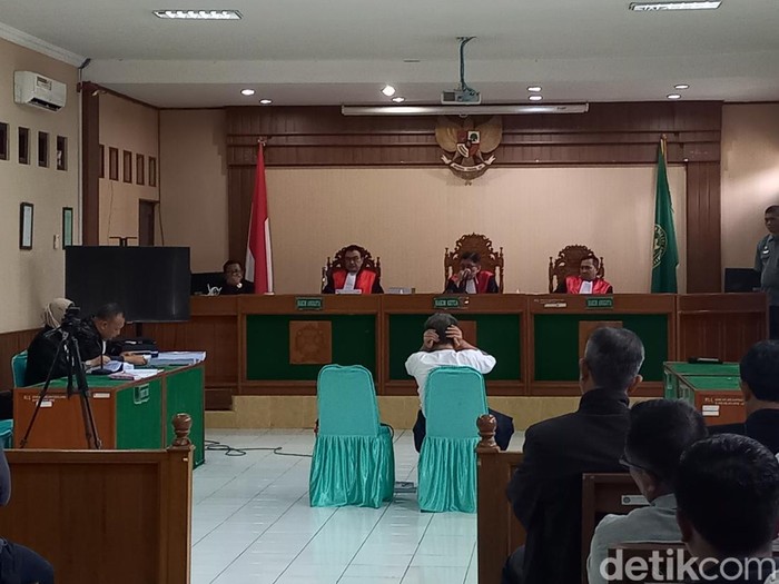 Bambang Tri menutup telinga dalam persidangan di Pengadilan Negeri Solo, Selasa (21/3/2023).