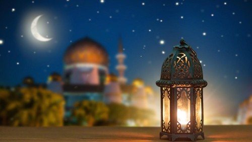 Ramadan Kareem greeting. Islamic lantern on night sky with crescent moon and stars. End of fasting. Hari Raya card. Eid al-Fitr decoration. Breaking of holy fast day. Muslim holiday.