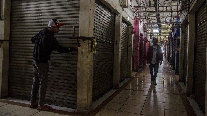 Pedagang menutup kios di Pasar Cimol Gedebage, Bandung, Jawa Barat, Rabu (22/3/2023). Pasar tersebut ditutup untuk sementara atas inisiatif dari para pedagang terkait adanya larangan dari pemerintah terhadap aktivitas perdagangan pakaian bekas impor. ANTARA FOTO/Novrian Arbi/tom.