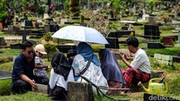 Mereka terlihat datang bersama keluarganya, berjalan masuk menapaki pinggir makam untuk sampai ke makam keluargannya.
