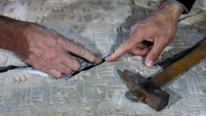 Members of a French team, specialized in the restoration of antiquities, restore the antiquities in the Mosul Museum, which were destroyed by the Islamic State militants in Mosul, Iraq, March 11, 2023. REUTERS/Khalid al-Mousily