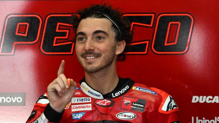 (FILES) In this file photo taken on February 10, 2023 Ducati Lenovos Italian rider Francesco Bagnaia gestures inside his team garage during the first day of the pre-season MotoGP winter test at the Sepang International Circuit in Sepang. - Double win for Francesco Bagnaia or revenge for Fabio Quartararo? The Italian will go back to Portugal this weekend in the hunt to retain his MotoGP title, but he will be up against the Frenchman, who has the same ambition, to be crowned double king in the premier class. (Photo by Mohd RASFAN / AFP)