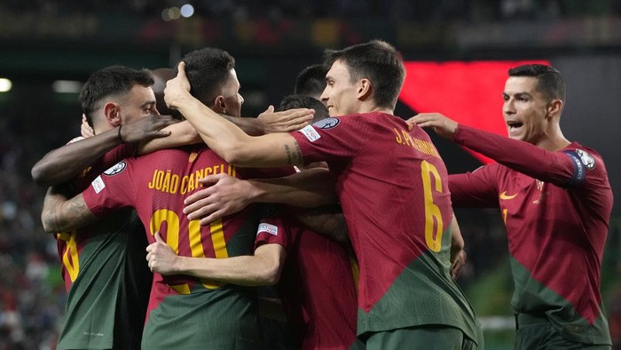 Portugal players celebrate after Portugals Bernardo Silva scored his sides second goal during the Euro 2024 group J qualifying soccer match between Portugal and Liechtenstein at the Jose Alvalade stadium in Lisbon, Portugal, Thursday, March 23, 2023. (AP Photo/Armando Franca)