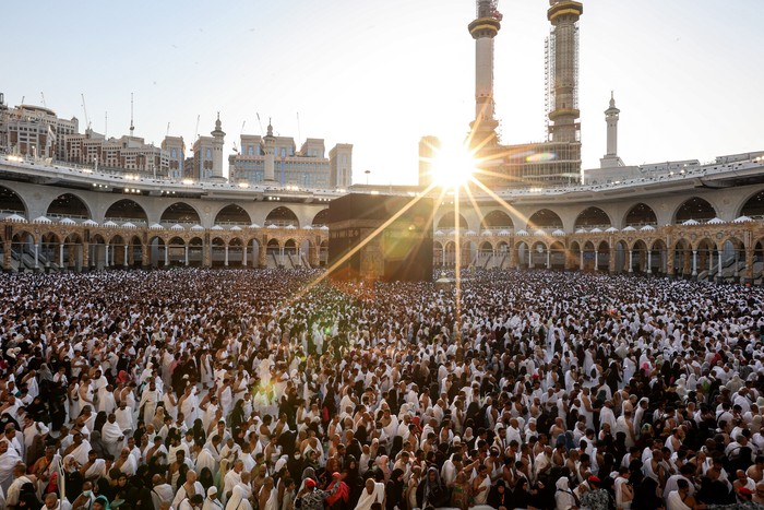 Muslim worshippers gather before the Kaaba, Islams holiest shrine, as they perform the Maghrib (sunset) prayer to mark the end of the first day of fasting in the holy month of Ramadan, at the Grand Mosque in the holy city of Mecca on March 23, 2023. (Photo by Abdel Ghani BASHIR / AFP) (Photo by ABDEL GHANI BASHIR/AFP via Getty Images)