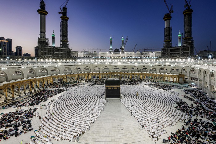 Muslim worshippers gather before the Kaaba, Islams holiest shrine, as they perform the Maghrib (sunset) prayer to mark the end of the first day of fasting in the holy month of Ramadan, at the Grand Mosque in the holy city of Mecca on March 23, 2023. (Photo by Abdel Ghani BASHIR / AFP) (Photo by ABDEL GHANI BASHIR/AFP via Getty Images)