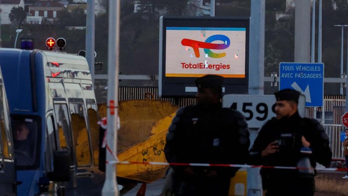 Tolak Reformasi Pensiun, Karyawan TotalEnergies Mogok Kerja Police officers stand near the TotalEnergies refinery, on the day French riot police pushed back energy workers on strike as they gathered in front of the refinery to protest against the French government's pensions reform, in Gonfreville-L’Orcher near Le Havre, France, March 24, 2023. REUTERS/Pascal Rossignol