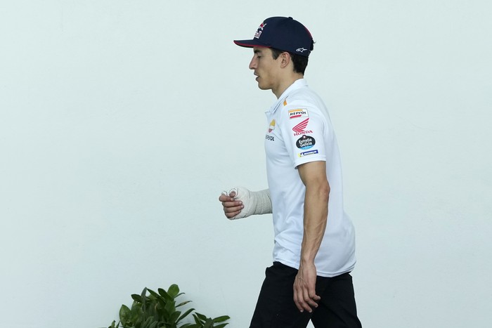 MotoGP rider Marc Marquez of Spain walks in the paddock after getting injured in a crash during the Portugal Motorcycle Grand Prix, at the Algarve International circuit near Portimao, Portugal, Sunday, March 26, 2023. (AP Photo/Jose Breton)