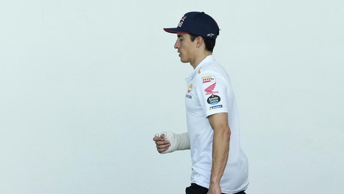 MotoGP rider Marc Marquez of Spain walks in the paddock after getting injured in a crash during the Portugal Motorcycle Grand Prix, at the Algarve International circuit near Portimao, Portugal, Sunday, March 26, 2023. (AP Photo/Jose Breton)
