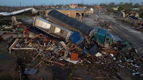A law enforcement vehicle is seen underneath a fallen tree after thunderstorms spawning high straight-line winds and tornadoes ripped across the state in Rolling Fork, Mississippi, U.S., March 25, 2023. REUTERS/Cheney Orr