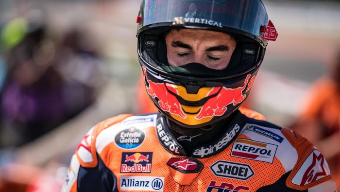 PORTIMAO, ALGARVE, PORTUGAL - MARCH 26: Marc Marquez of Spain and Repsol Honda Team walks out of the gravel, after he crashed with local hero Miguel Oliveira of Portugal and CryptoDATA RNF MotoGP Team during the race of the MotoGP Grande Prémio TISSOT de Portugal  at Autodromo do Algarve on March 26, 2023 in Portimao, Algarve, Portugal. (Photo by Steve Wobser/Getty Images)