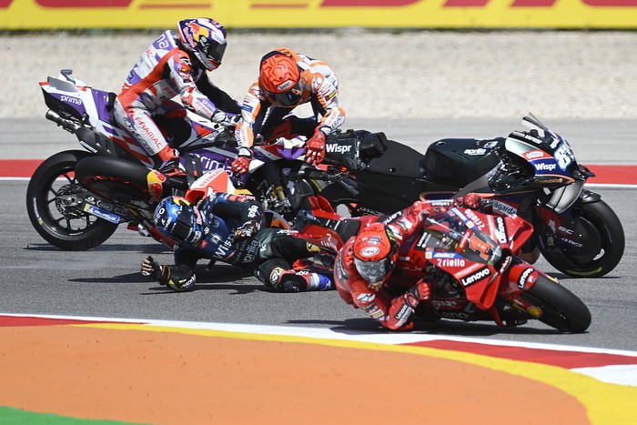 Honda Spanish rider Marc Marquez falls after crashing with Aprilia Portuguese rider Miguel Oliveira (out of frame) during the MotoGP race of the Portuguese Grand Prix at the Algarve International Circuit in Portimao, on March 26, 2023. (Photo by PATRICIA DE MELO MOREIRA / AFP) (Photo by PATRICIA DE MELO MOREIRA/AFP via Getty Images)