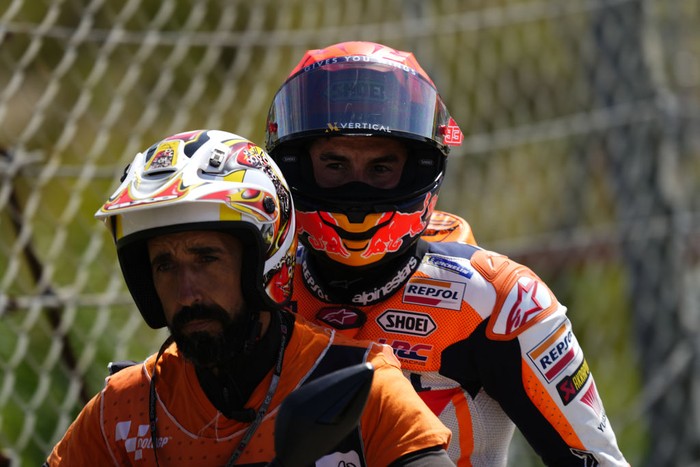Honda Spanish rider Marc Marquez falls after crashing with Aprilia Portuguese rider Miguel Oliveira (out of frame) during the MotoGP race of the Portuguese Grand Prix at the Algarve International Circuit in Portimao, on March 26, 2023. (Photo by Jose Hernandez/Anadolu Agency via Getty Images)