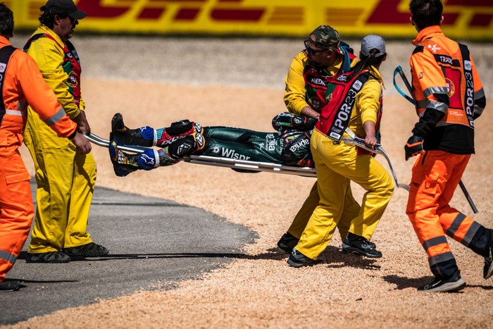 Honda Spanish rider Marc Marquez falls after crashing with Aprilia Portuguese rider Miguel Oliveira (out of frame) during the MotoGP race of the Portuguese Grand Prix at the Algarve International Circuit in Portimao, on March 26, 2023. (Photo by Steve Wobser/Getty Images)