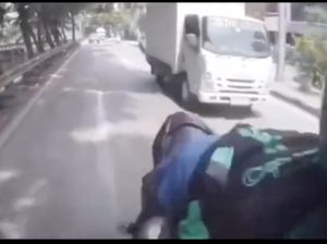 Duh! Diduga Main HP Sambil Berkendara, Kepala Ojol Hampir Terlindas Truk