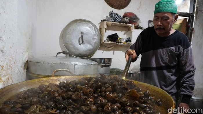 Chamlani (63) mengolah masakan keong khas bulan Ramadan di kediamannya jalan Kauman Lama, Purwokerto Timur, Kabupaten Banyumas, Rabu (29/3/2023).