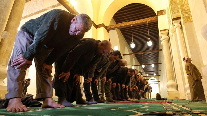Muslim men perform ablution from the water before performing prayers inside al-Hakim bi-Amr Allah Mosque, named after the sixth Fatimid caliph, which reopened for visitors on Monday night after renovations in old Islamic Cairo, Egypt February 27, 2023. The renovation project for Egypt's fourth oldest mosque which its second largest, began in 2017 with a budget of 85 million Egyptian pounds (around 2.8 million USD) in collaboration between Egypt’s antiquities authority and Bohra Shia. REUTERS/Amr Abdallah Dalsh