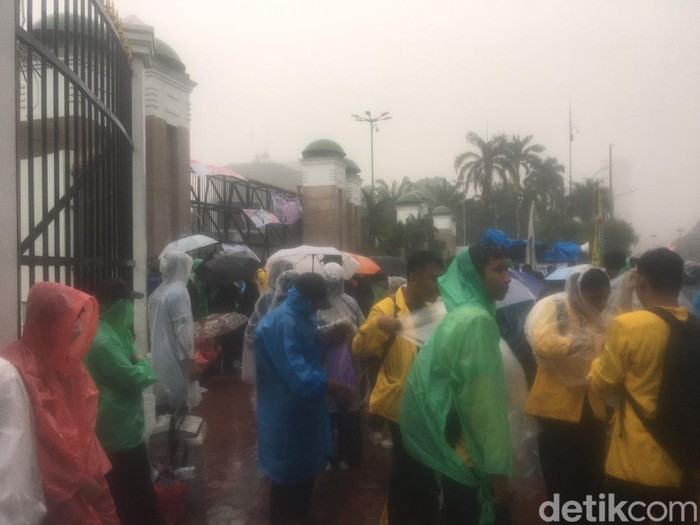 Pedagang Jual Jas Hujan di Depan DPR