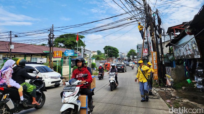 Petugas memperbaiki kabel semrawut di kawasan Pesanggrahan, Jakarta Selatan, Kamis (30/3/2023). Pemprov DKI secara bertahap merelokasi kabel yang semrawut dengan menanam di bawah tanah. Selain estetika, jaringan kabel bawah tanah dinilai lebih aman.