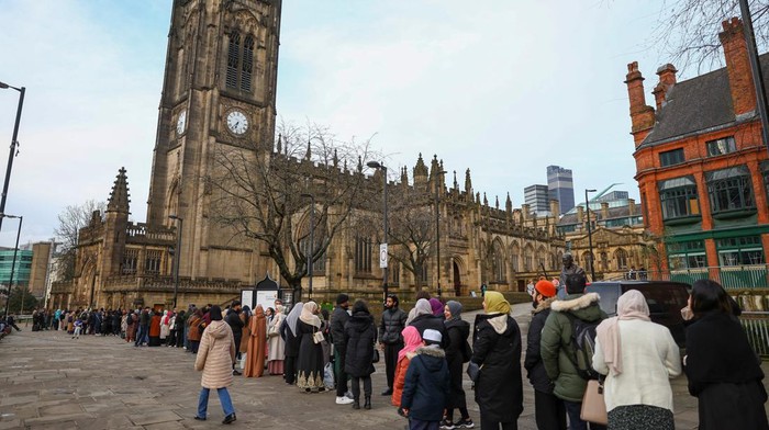 People eat while breaking their fast during the Muslim holy fasting month of Ramadan, at Manchester Cathedral, in Manchester, Britain, March 29, 2023. REUTERS/Molly Darlington