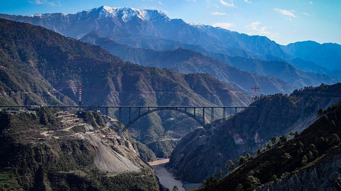 KATRA, INDIA - MARCH 26: A view of newly constructed Chenab Bridge, Worlds highest Rail arch bridge of Indian Railways on Udampur- Srinagar-Baramulla-Rail link project during its media preview in Reasi district, on March 26, 2023 in Katra, India. The bridge is supported by 96 cables, making it stronger and suitable for trains running at speeds of up to 100 kmph, a senior officer of northern railways was quoted as saying in a report. (Photo by Sanchit Khanna/Hindustan Times via Getty Images)