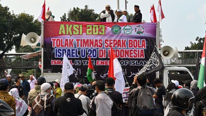 Indonesians take part in a rally in Jakarta on March 20, 2023 to demand their government to reject the participation of Israels team in the upcoming 2023 FIFA U-20 World Cup, which is to be hosted by Indonesia between May 20 and June 11. (Photo by ADEK BERRY / AFP) (Photo by ADEK BERRY/AFP via Getty Images)