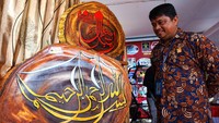 Petugas Lembaga Pemasyarakatan (Lapas) Boalemo menunjukan kaligrafi berbahan kayu jati pada pameran One Day One Prisons Product di kantor wilayah Kementerian Hukum dan HAM Gorontalo di Kabupaten Bone Bolango, Gorontalo, Jumat (31/3/2023).