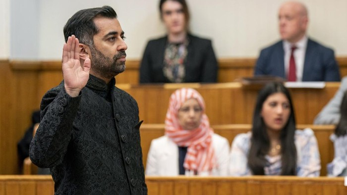 Humza Yousaf takes the oath as he is sworn in as First Minister of Scotland at the Court of Session, in Edinburgh, Wednesday March 29, 2023. Yousaf was confirmed as first minister of Scotland on Tuesday, becoming the first person of color to head the Scottish government, and the first Muslim national leader in any Western democracy. (Jane Barlow/PA via AP)