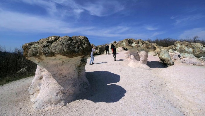Visitors attend in front of The stone mushrooms rock formations, located near the village of Beli Plast, south east of the Bulgarian capital Sofia.The rock formations have the shape of natural mushrooms - their stalks are pink, and the caps are green. The height of the mushroom stalks and the width of the caps are up to 2.5 meters. They are made of rhyolite volcanic tuffs, which are the result of intensive underwater volcanic activity, dating back to the Paleocene. After the sea withdrawal and the consistent seabed rising, the influence of the erosion became visible. The rock formation is one of the most famous tourist attraction in Bulgaria. (Photo by /Sky Pictures Bulgaria/NurPhoto via Getty Images)