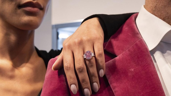 A woman shows a 10.57 carat pink diamond at Sotheby's, Monday, March. 27, 2023, in New York. The diamond, named The Eternal Pink, will be featured in Sotheby's Magnificent Jewels auction on June 8 and is expected to achieve in excess of $35 million. (AP Photo/Yuki Iwamura)