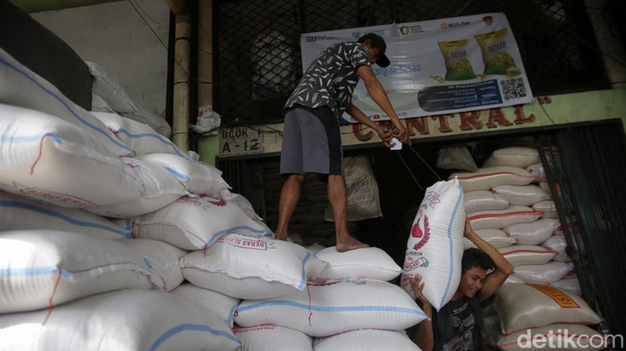 Bunda Sabar Ya, Harga Beras Resmi Naik! Pekerja memanggul beras di Pasar Induk Cipinang, Minggu (2/4/2023). Pemerintah melalui Badan Pangan Nasional secara telah meningkatkan Harga Eceran Tertinggi (HET) beras. Artinya saat ini harga beras resmi naik alias semakin mahal.