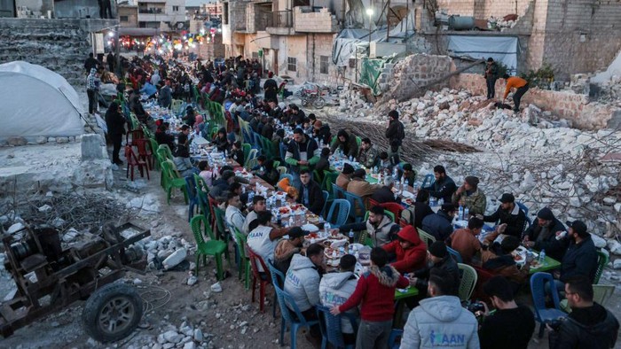 Locals affected by the February 6 earthquake attend a mass 
